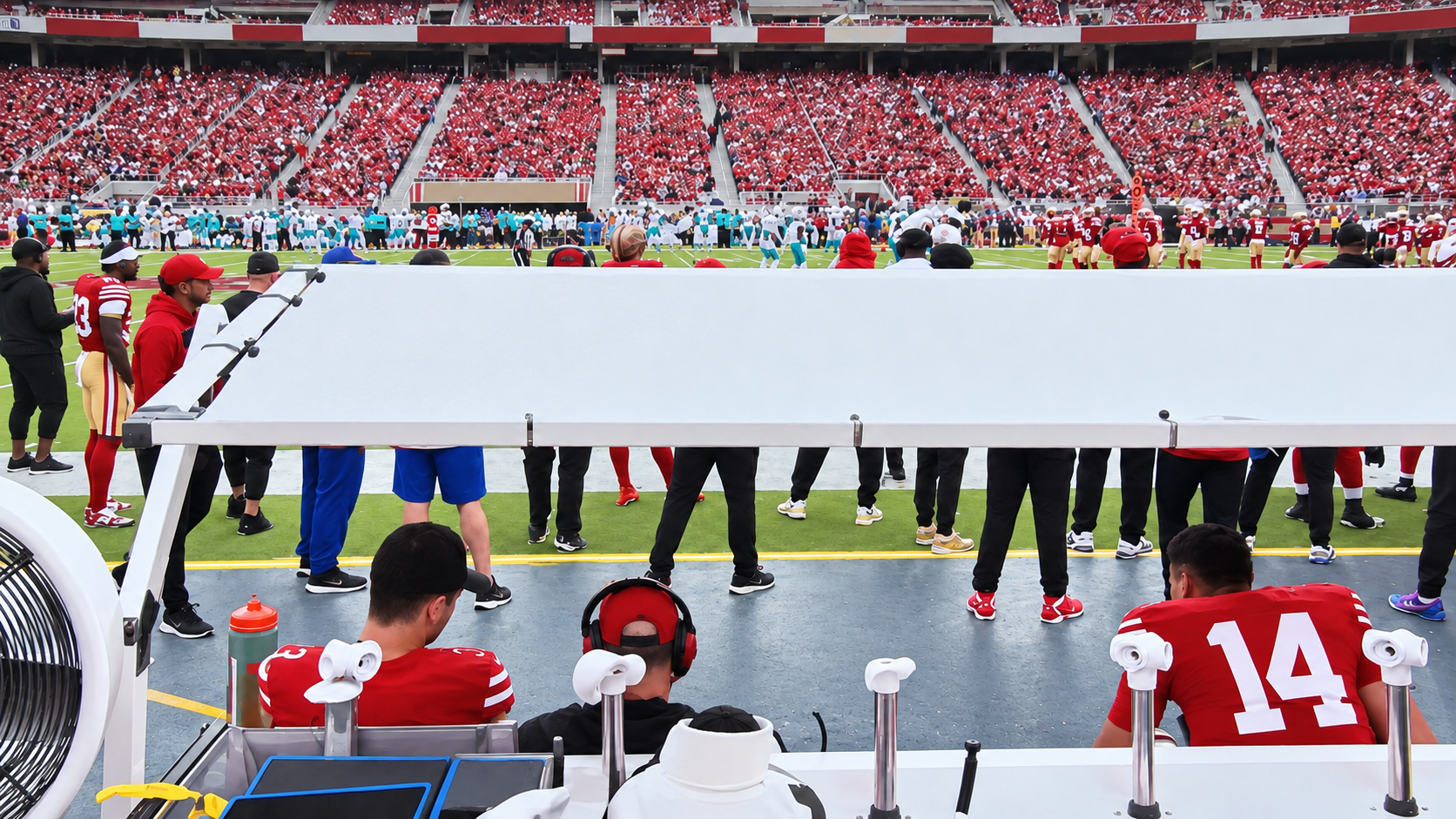 Podium Shades sideline canopy viewed from beneath, covering a professional football bench area